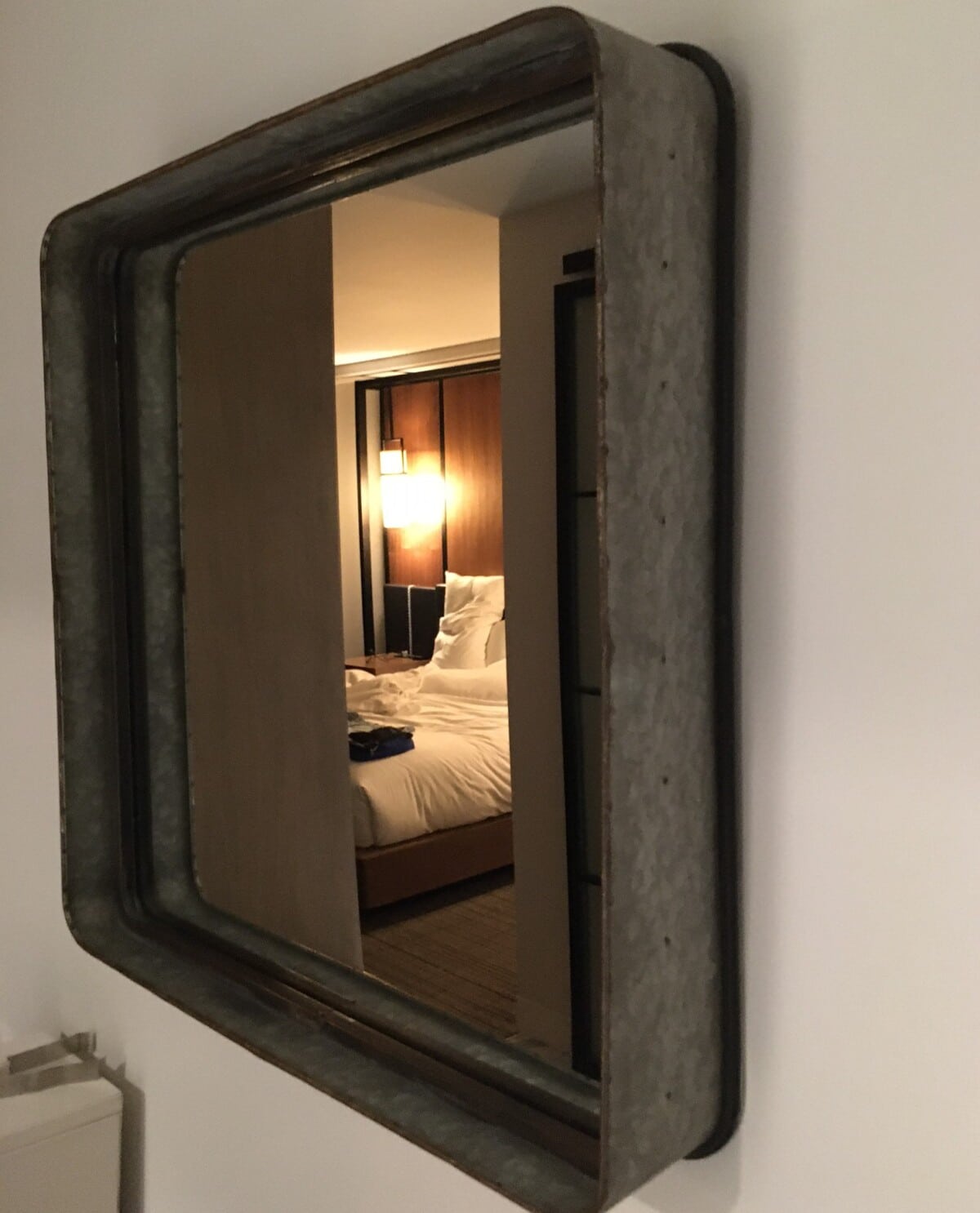 Repurposed metal mirror frame in a guest room at The Kimpton Aertson Hotel