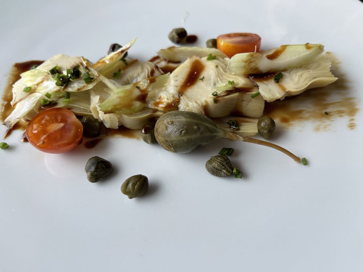 Artichoke Heart Capaccio with celery, capers, and chives with a balsamic dressing.