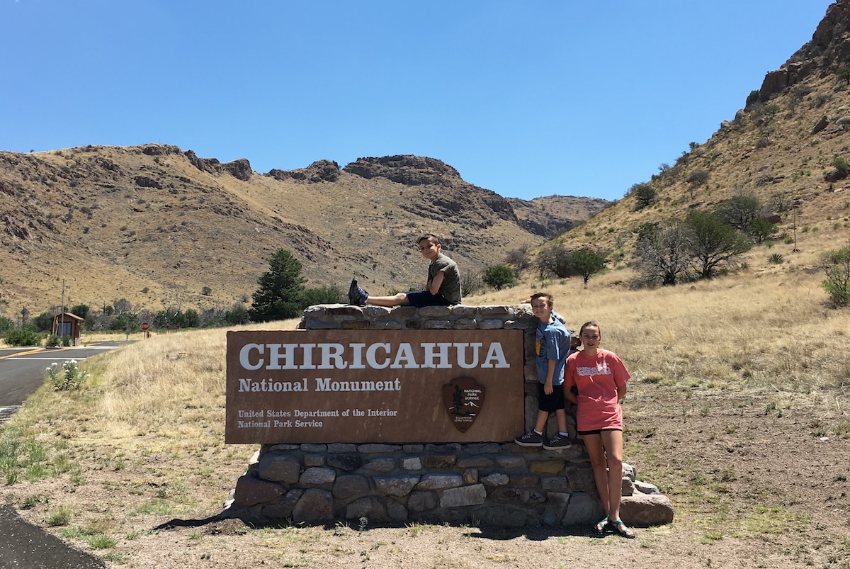 Kids in front of Chiricahua sign.