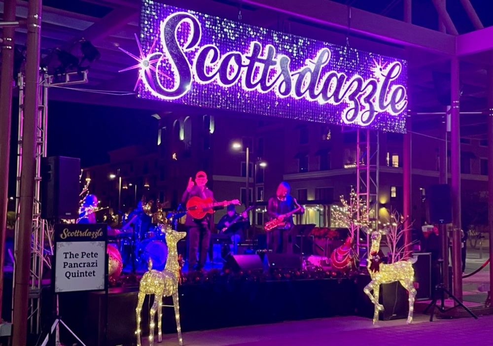 Lighted stage at Scottsdazzle with band performing.