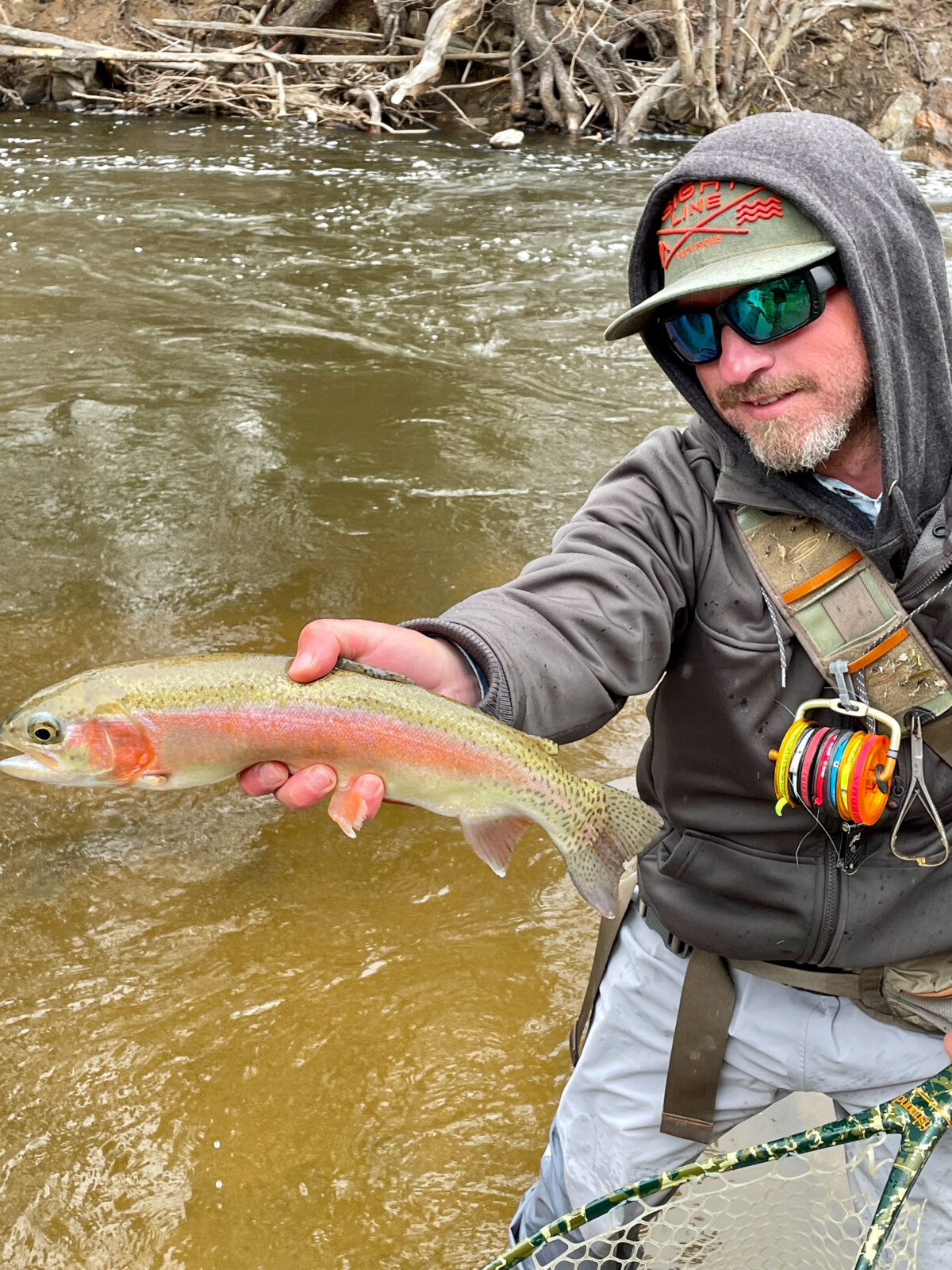 Fly fishing guide with a rainbow trout