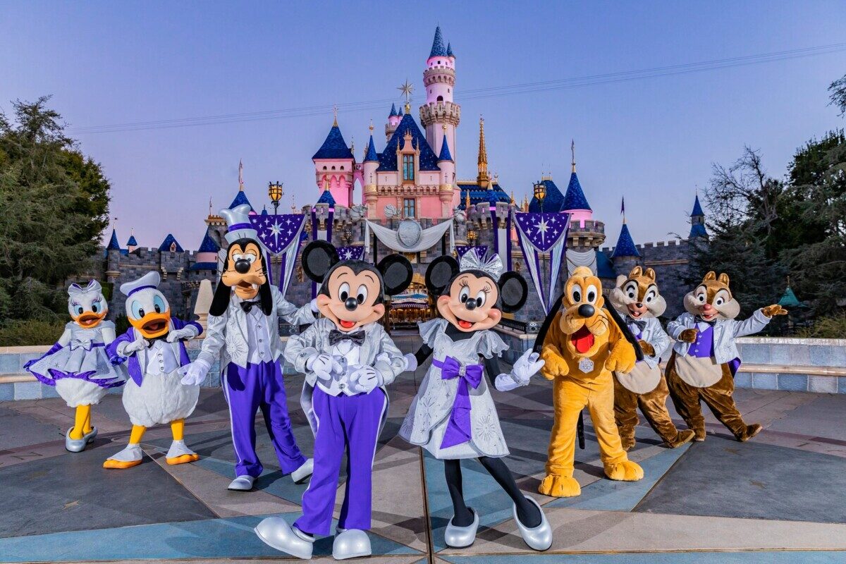Mickey Mouse, Minnie Mouse and their pals pose in front of Sleeping Beauty Castle in their shimmering new looks at the Disneyland Resort in Anaheim Calif, that begins commemorating The Walt Disney Company's 100th anniversary on Jan. 27, 2023, with special, limited-time celebrations taking place throughout the resort all year long. The resort will feature new platinum-infused décor, two new nighttime spectaculars, special food and beverage, merchandise offerings and more. (Christian Thompson/Disneyland Resort)
