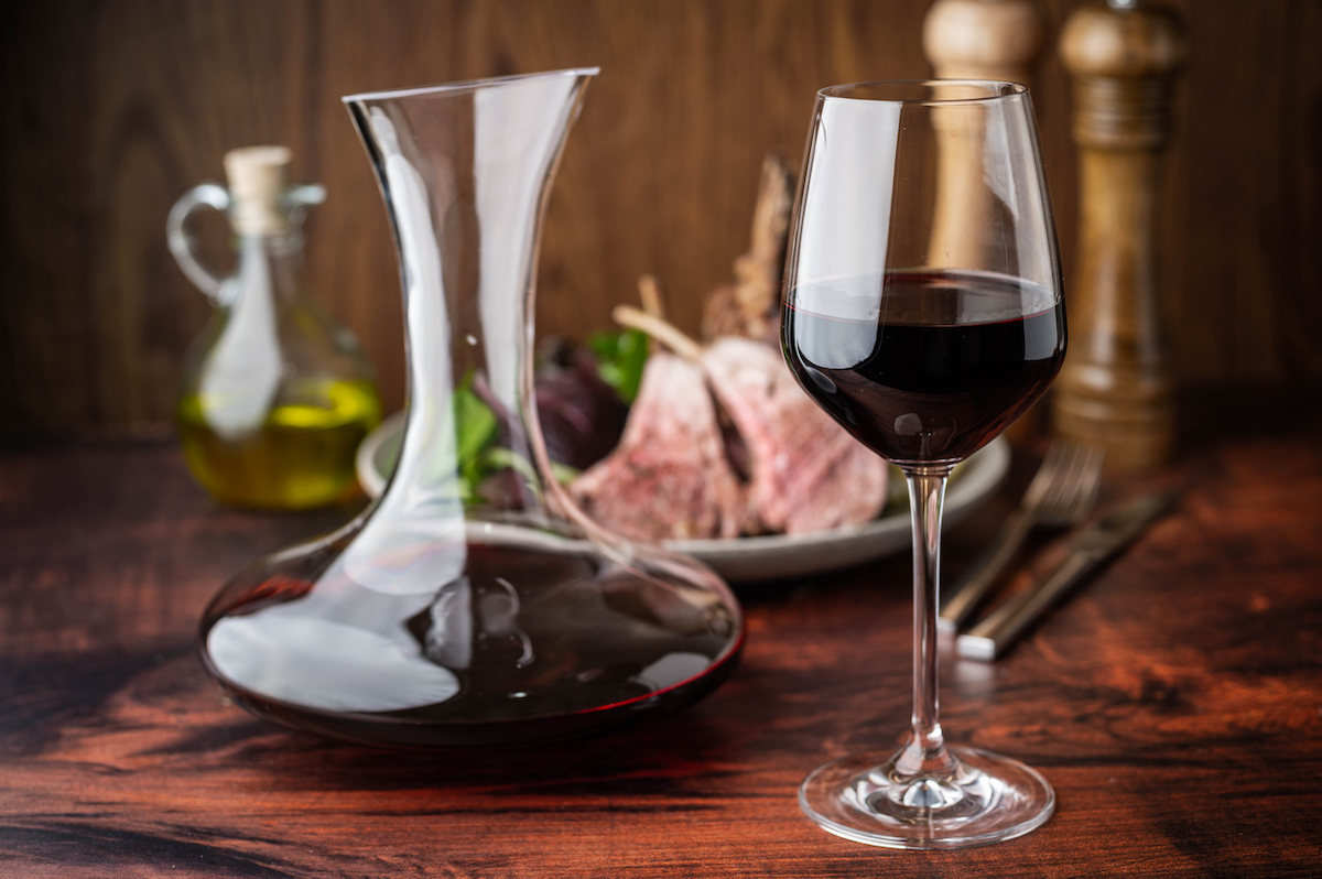 red wine glass with decanter and lamb rack
