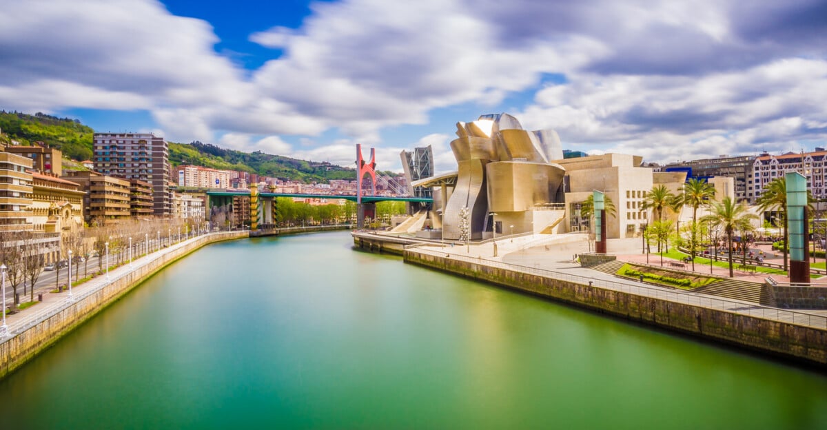 The cityscape of Bilbao, Spain. The Nervion river crosses Bilbao downtown, hosting in its margins the traditional and modern buildings of the city.