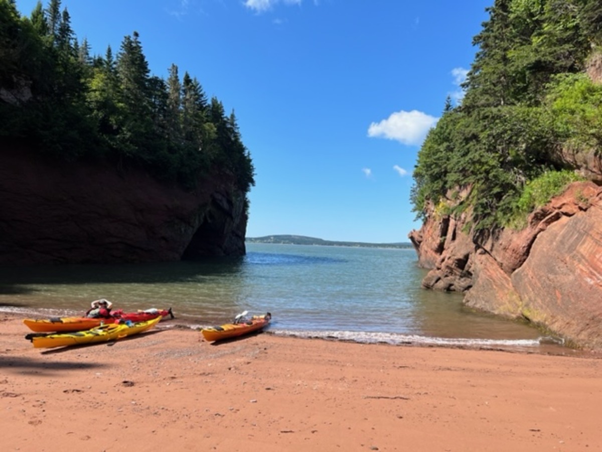 sea kayaking on the bay of fundy -break time in a secluded cove
