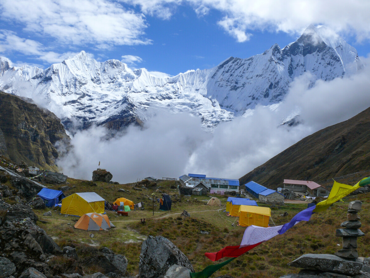 Tents in Annapurna Base camp with a view of Mount Machapuchare. Photo by strobl.r via DepositPhotos