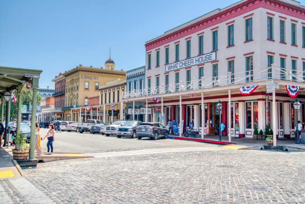 Historic buildings line the street in Old Town Sacramento near the waterfront.